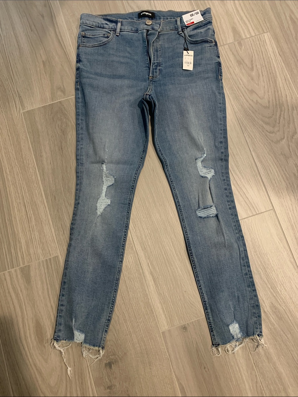 Express Medium Blue Skinny Jeans with Distressed Knees and Frayed Hem